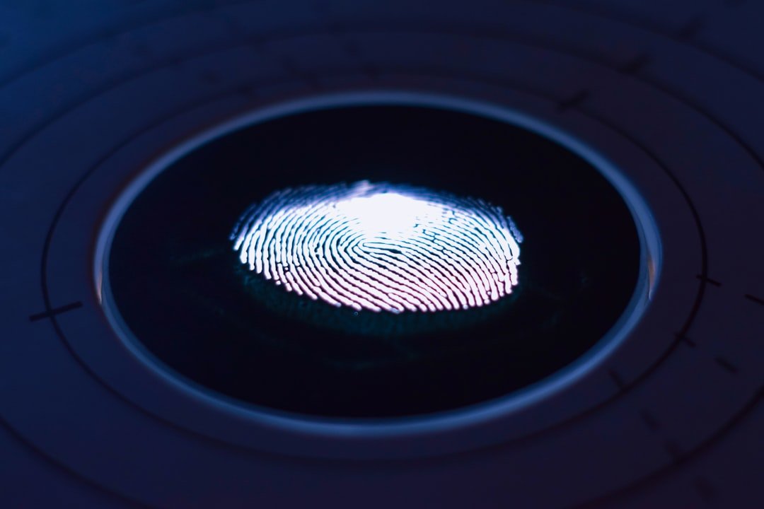 Glowing fingerprint on a dark biometric scanner