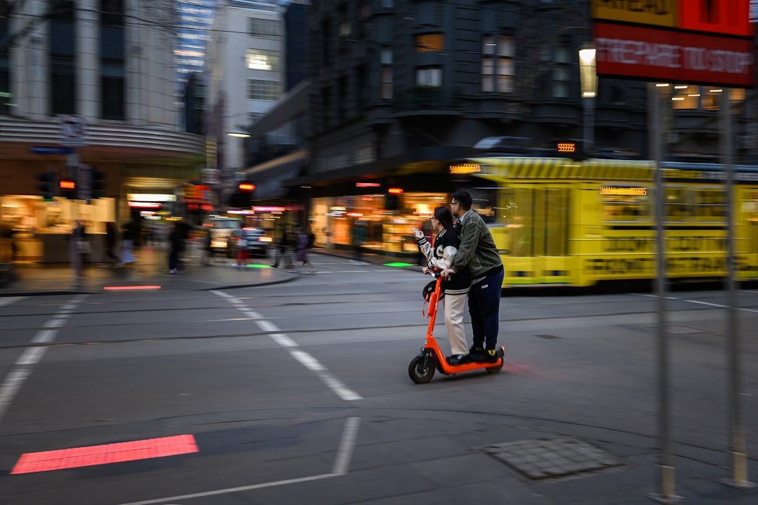 Person riding an electric scooter on a city street