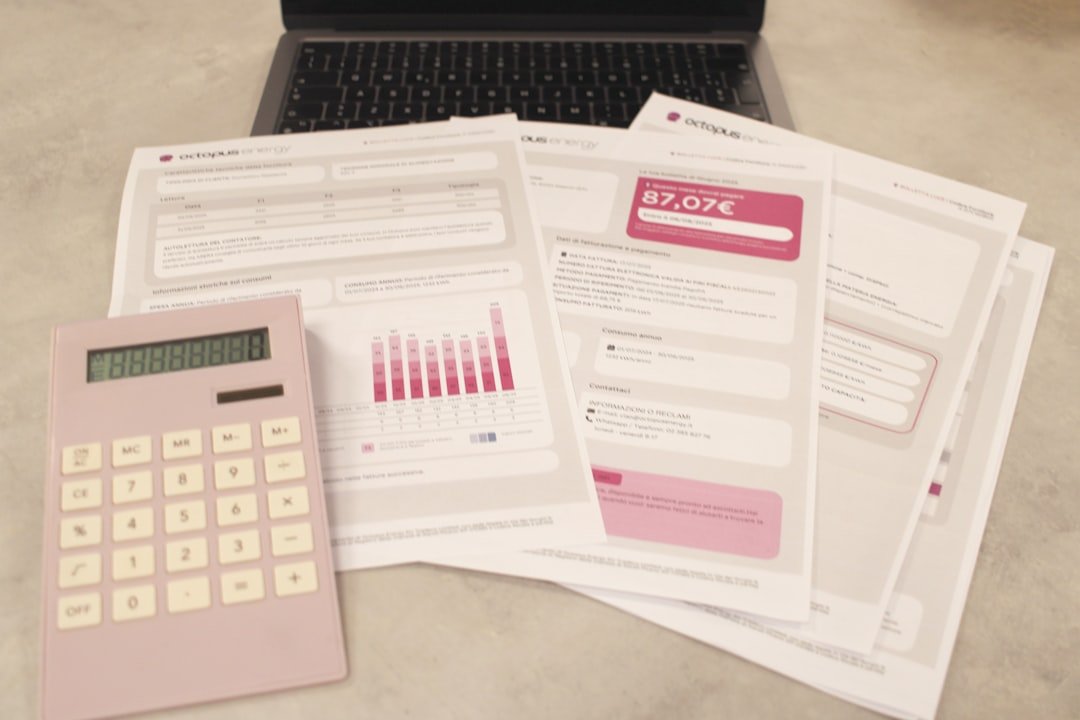 Calculator, bills and laptop representing small business accounting