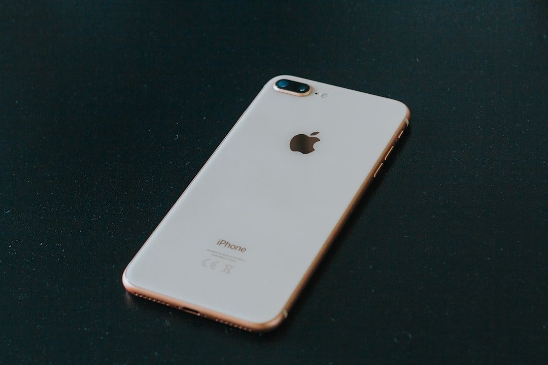 Gold iPhone on a black surface
