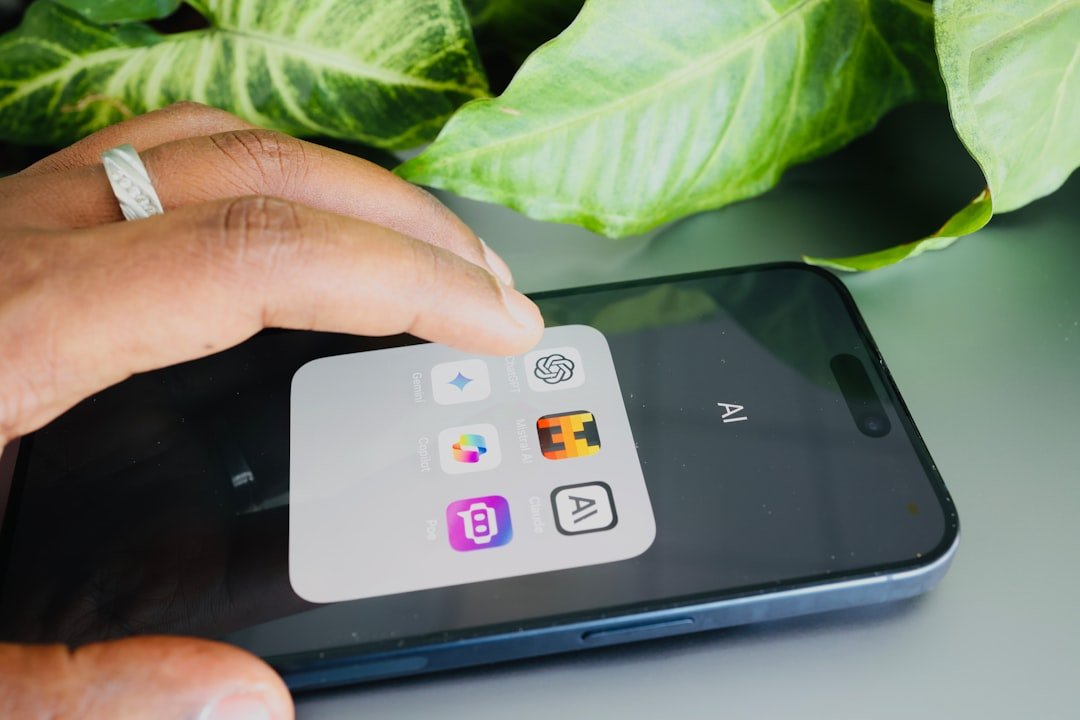 Person holding a phone showing app icons
