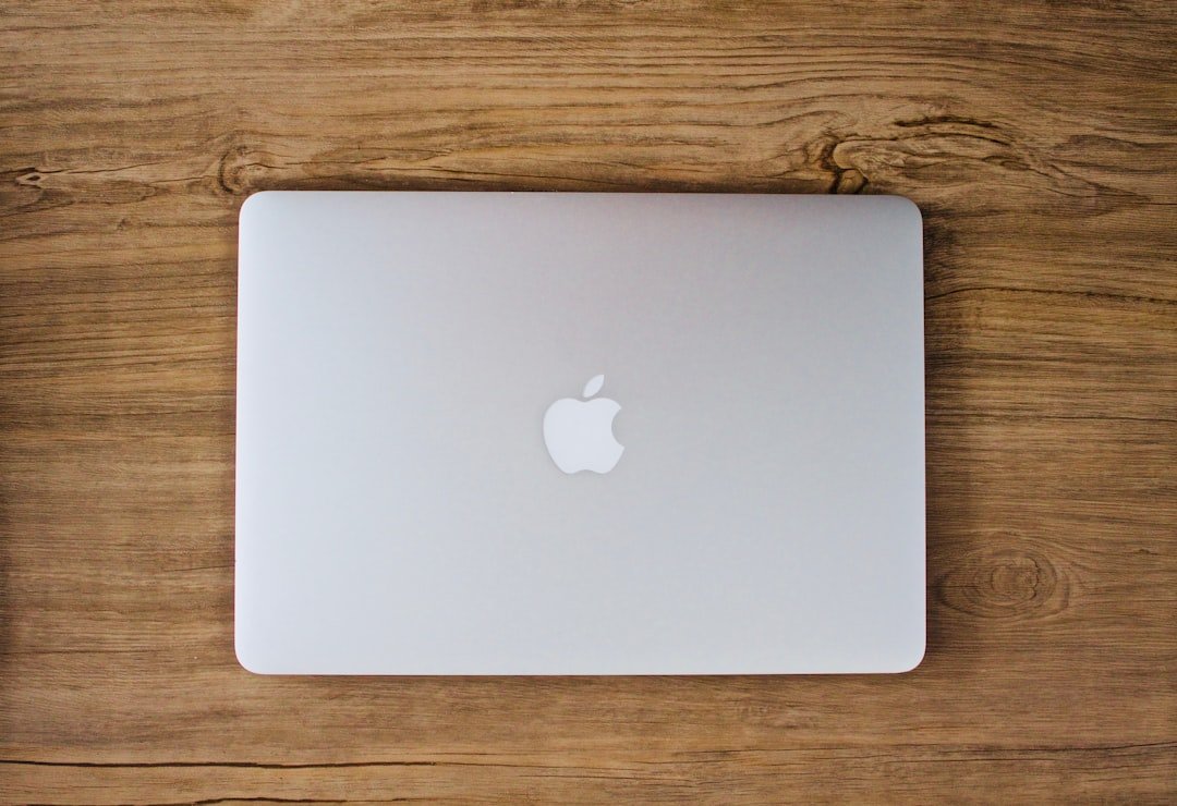 Silver MacBook Air on a wooden desk