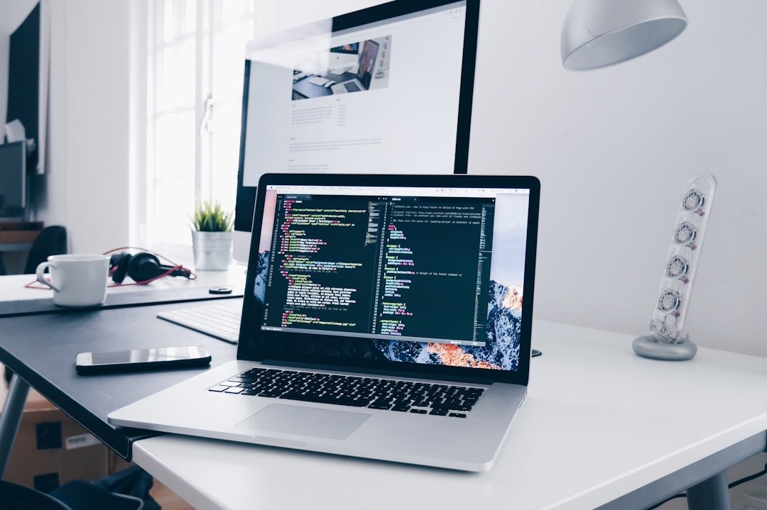Laptop with code on screen representing website building platforms